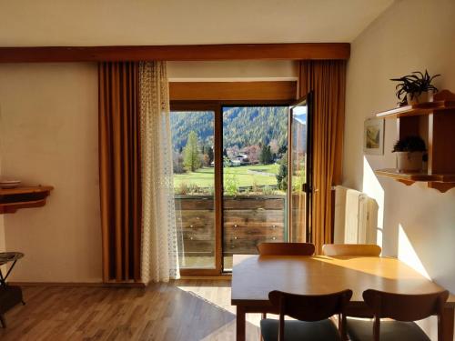 a dining room with a table and a large window at Landhaus Penker in Mallnitz