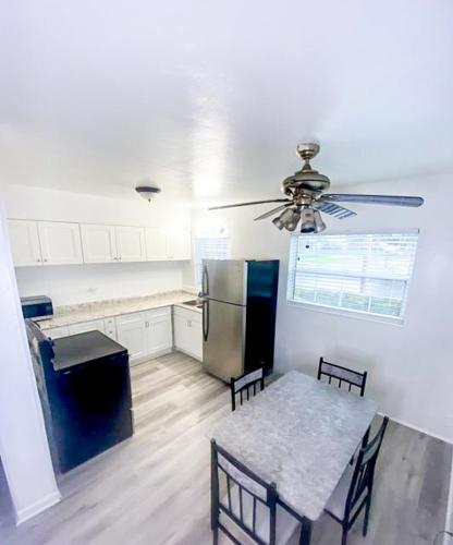 a kitchen with a table and a ceiling fan at Uptown Inn & Suites in St. Petersburg