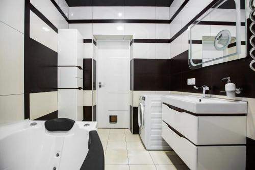 a black and white bathroom with a sink and a toilet at Brand new relaxing place in nice neighbourhood in Lviv