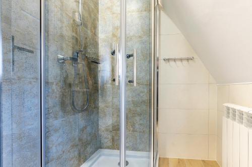 a shower with a glass door in a bathroom at 9 Sił Murowany Dom in Bukowina Tatrzańska