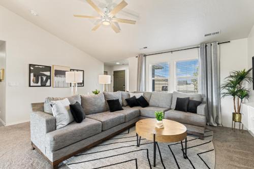 a living room with a couch and a table at Modern Comfort Caldwell 3b2b Home Sleeps 8! in Caldwell