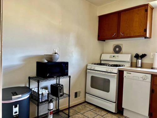 a kitchen with a white stove and a microwave at NEW 3 BRD Modern Urban Gateway in Arlington