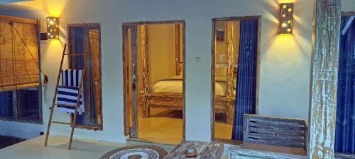 a room with a bedroom with a bed and a mirror at Oasis Villas in Gili Trawangan