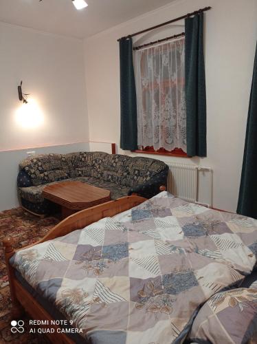 a living room with a bed and a couch at Atlantis Apartmán 3 in Klášterec nad Ohří