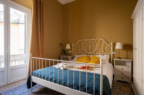 sypialnia z białym łóżkiem i niebieskim kocem w obiekcie CORVETTO rooms w Genui