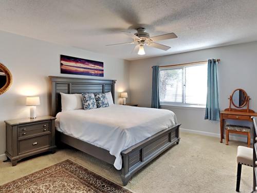 a bedroom with a bed and a ceiling fan at Sandy Key #223 in Perdido Key