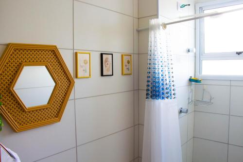 a bathroom with a mirror and a shower at Perto do Mar, 5G, Ar e Piscina C/Churrasqueira in João Pessoa
