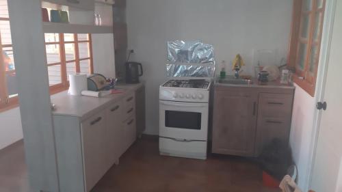 a kitchen with a stove and a counter top at Cabaña Recreo in Viña del Mar