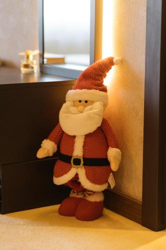 a santa claus toy is leaning against a wall at Woodside TEA Residences & SPA Kopaonik in Kopaonik