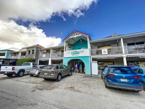 a group of cars parked in front of a building at The Beach central 50m from Orient Bay Beach in Orient Bay