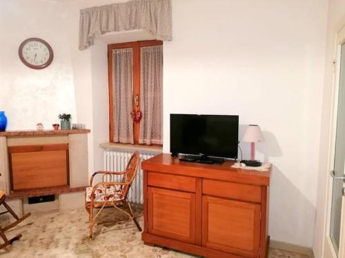 - un salon avec une télévision sur une commode en bois dans l'établissement Casa Fontanelle, à Celano