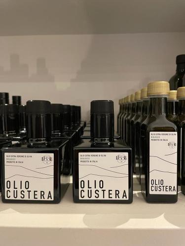 a group of bottles sitting on top of a shelf at Baglio Custera in Marsala