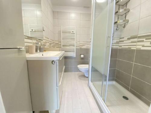 une salle de bain avec une douche, un lavabo et des toilettes dans l'établissement 2 pièces 59m2 face à la plage, à Roscoff