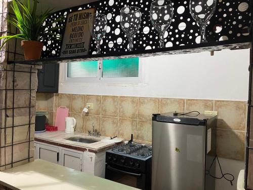 a kitchen with a sink and a stove top oven at alquiler temporal DIARIO DE IRIGOYEN in Formosa
