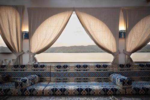 a couch in a room with a large window at Noprea Boutique Hotel in Aswan
