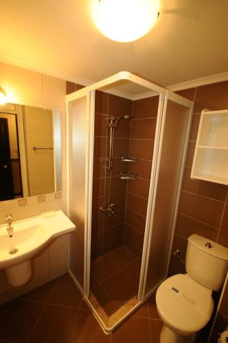a bathroom with a shower and a toilet and a sink at Hisar Holiday Club in Oludeniz