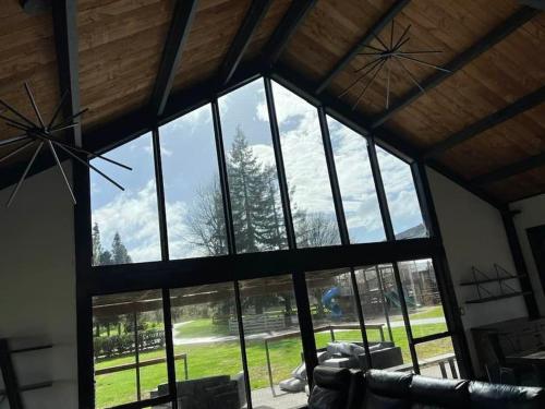 a large window in a living room with a view of a yard at The clubhouse in Hamilton