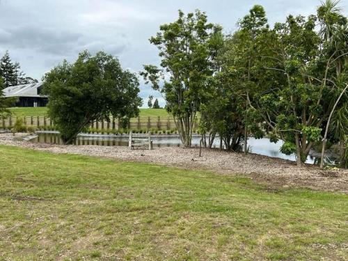 a park with a bench next to a body of water at The clubhouse in Hamilton