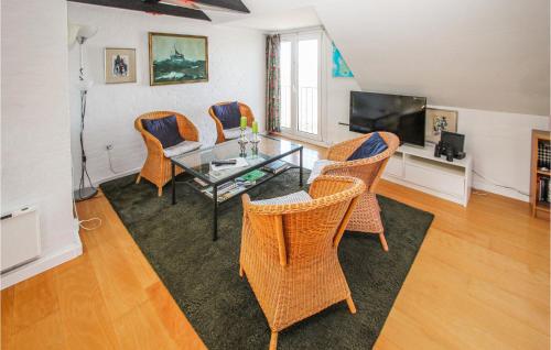 a living room with a glass table and chairs at 1 Bedroom Gorgeous Apartment In Samsø in Ballen
