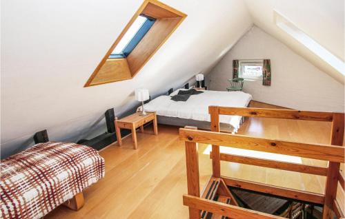 a bedroom with a bed in a attic at Beautiful Apartment In Sams With House Sea View in Ballen