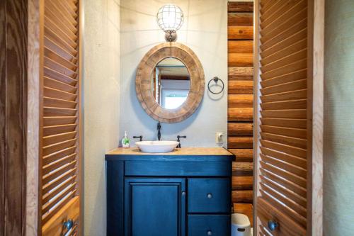 a bathroom with a blue sink and a mirror at Lakeside Escape in Lakehills