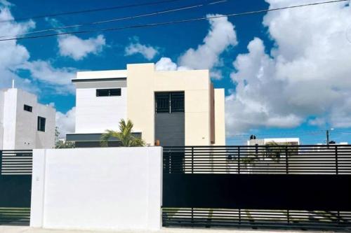 a white house with a fence in front of it at Modern Villa in Punta Cana - Villa Moderna in Punta Cana