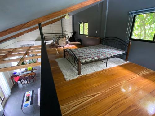 a living room with a bed and a staircase at Laguna Loft Camiguin in Mambajao