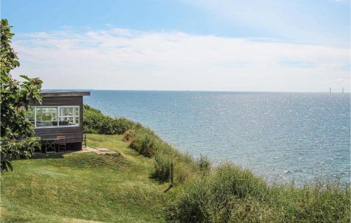 a house on the side of a hill overlooking the ocean at Udsigtspavillion in Kolby Kås