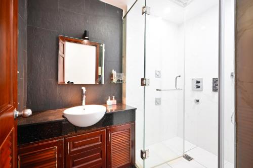 a bathroom with a sink and a shower at Huyen Homestay in Ho Chi Minh City