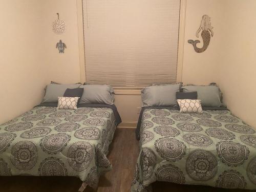a bedroom with two beds and a window at Hidden Beach Oasis in Myrtle Beach