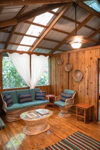 a living room with a couch and a table and chairs at Jaguar Creek in Good Living Camp
