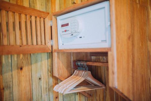 a small room with a tv in a wooden wall at Jaguar Creek in Good Living Camp