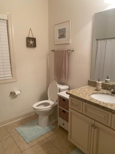 a bathroom with a toilet and a sink at Hidden Beach Oasis in Myrtle Beach