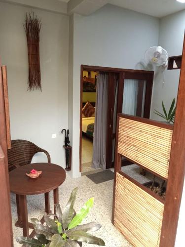 a room with a table and a chair and a mirror at Cocotinos Lembeh a Boutique Dive Lodge in Bitung