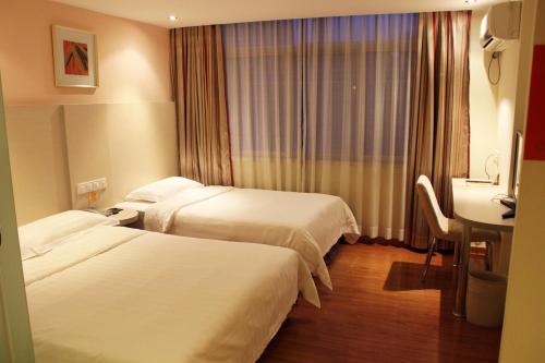 Un pat sau paturi într-o cameră la Shenzhen Green Oasis Hotel, Baoan