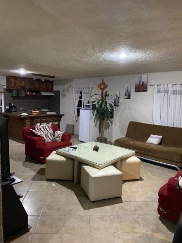 a living room with a couch and a table at Bonito departamento y Terrazas in Cholula