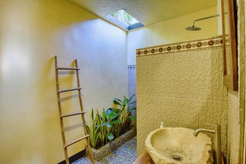 a bathroom with a shower and a toilet and a ladder at Puri Yalus Bungalow in Nusa Penida