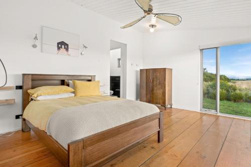 a bedroom with a bed and a ceiling fan at The Point Bass Coast in Bass