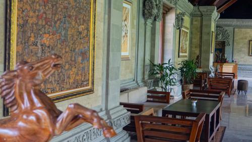 a statue of a horse on a wall in a restaurant at Sakti Garden Resort & Spa in Ubud
