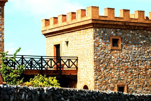 a building with a balcony on the side of it at El Castillo in Las Galeras