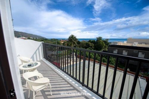 a balcony with chairs and a view of the ocean at Xiaoliuqiu 88 Homestay in Xiaoliuqiu
