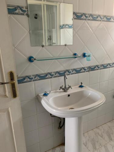 a bathroom with a white sink and a mirror at Villa hammamet in Hammamet