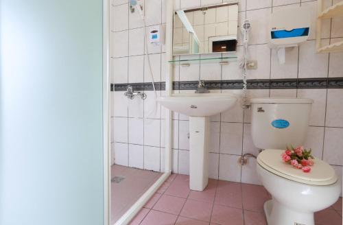 a bathroom with a toilet and a sink at Dongshan River Resort Farm in Wujie