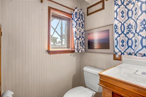 a bathroom with a toilet and a window at The Gypsy Palace in Saint Augustine