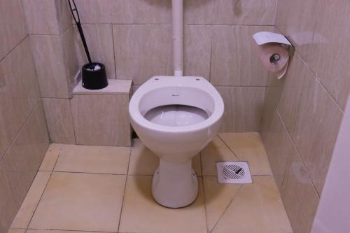 a bathroom with a white toilet in a stall at Vush Homes in Nairobi