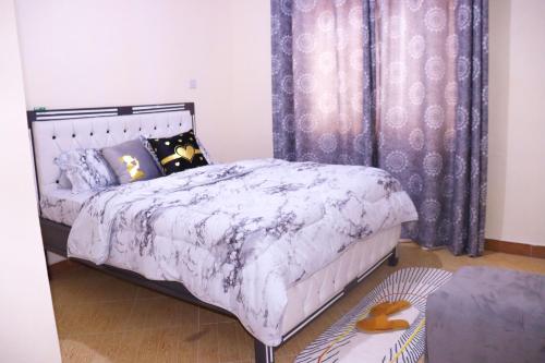 Postel nebo postele na pokoji v ubytování Vush Homes