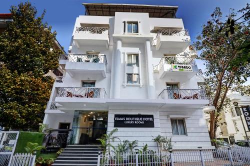 a white building with a sign in front of it at Treebo Trend Elmas Boutique in Bangalore