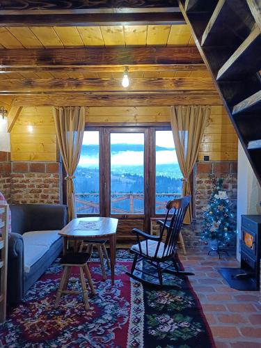 a living room with a couch and a table at Vikendica Tromedja Pale in Pale