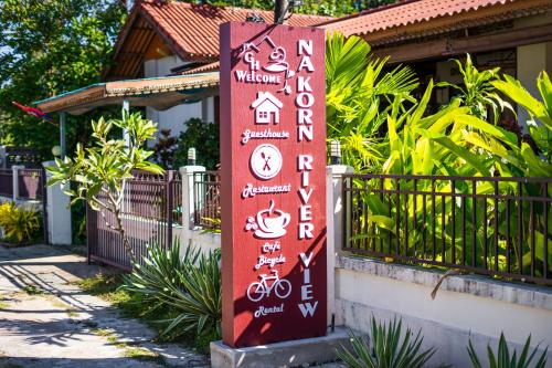 a sign for a hotel in front of a fence at Nakorn River View in Champasak