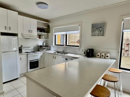 a kitchen with white appliances and a counter top at Captains Nook Cowes in Cowes